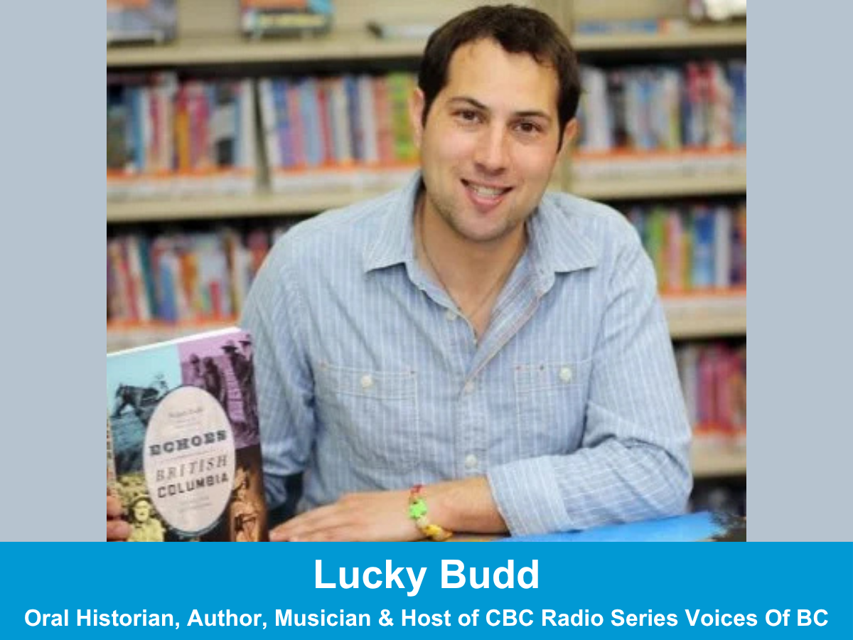 white male author sitting at desk with his books